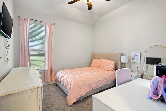 Bedroom featuring light carpet, ceiling fan, and lofted ceiling | Image 9
