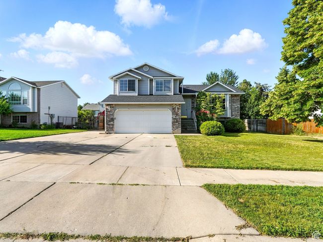 View of front facade with concrete driveway, an attached garage, and brick siding | Image 26