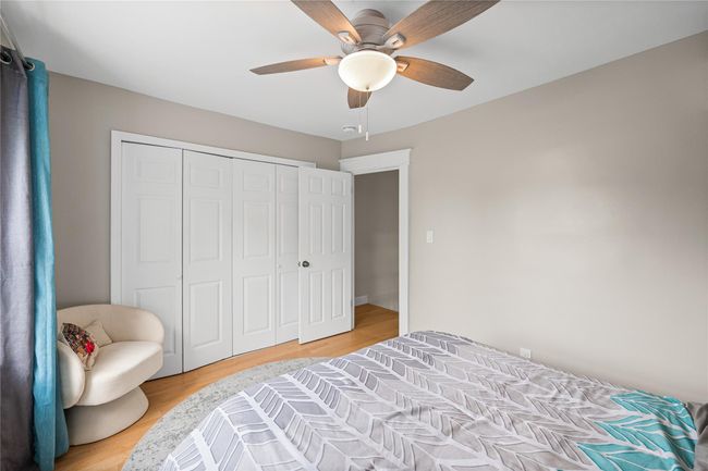 Bedroom with a closet, a ceiling fan, and light wood-style flooring | Image 23