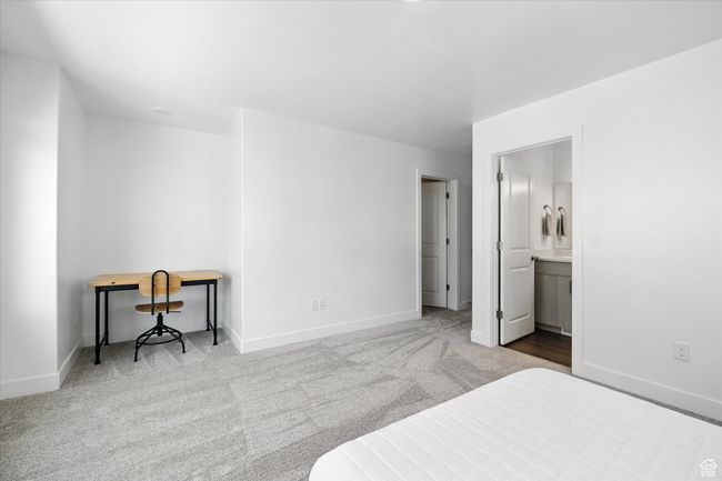 Bedroom with carpet floors and ensuite bathroom | Image 11