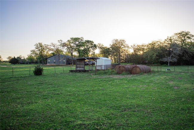 View of yard featuring an outdoor structure and a pole building | Image 7