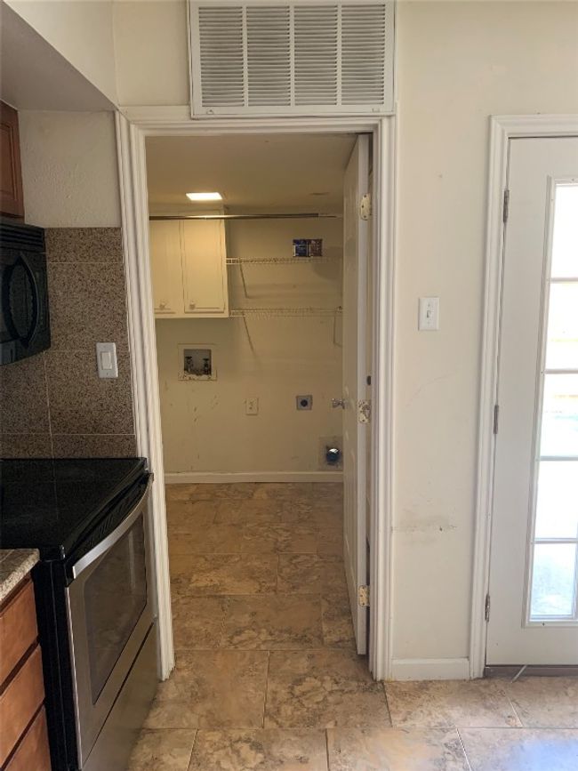 Laundry room with hookup for a washing machine, hookup for an electric dryer, and baseboards | Image 15