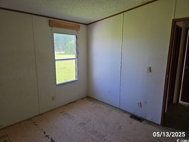 Empty room with plenty of natural light, ornamental molding, and a textured ceiling | Image 32
