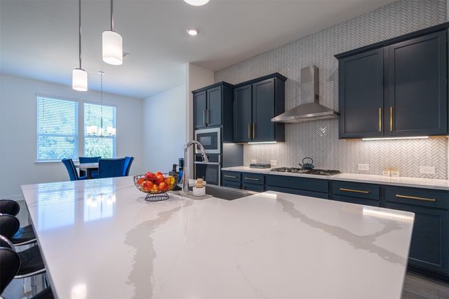 Views of the unique backsplash that adds character to the kitchen. | Image 15