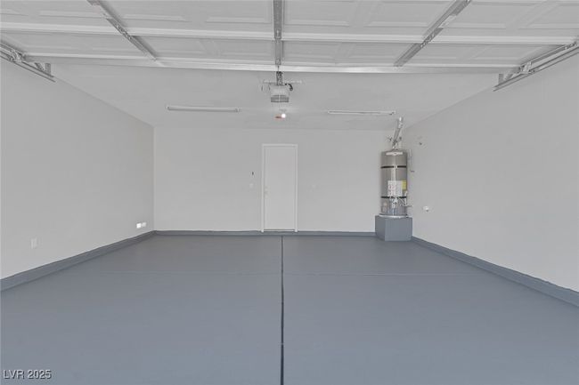 Garage featuring water heater and a garage door opener | Image 25