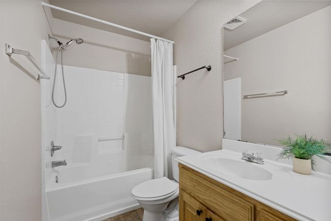 Full bathroom with visible vents, shower / bath combo, vanity, and toilet | Image 28