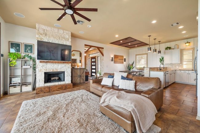 Living room featuring a ceiling fan, a wealth of natural light, and visible vents | Image 8