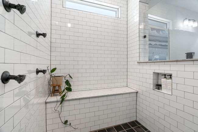 Full bathroom featuring tiled shower and tile walls | Image 21