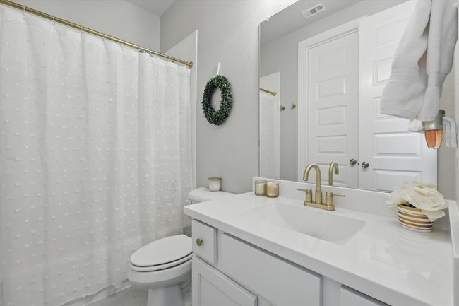 Bathroom with vanity, tile patterned flooring, and a shower with shower curtain | Image 20