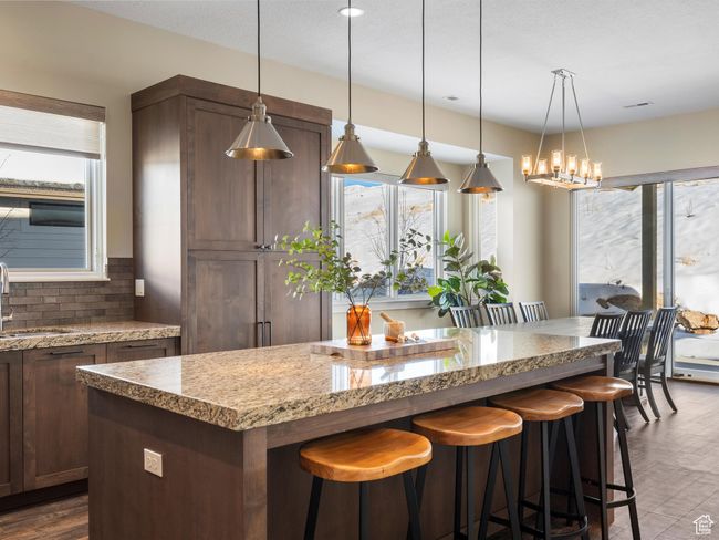 Kitchen with a sink, plenty of natural light, a center island, and backsplash | Image 18