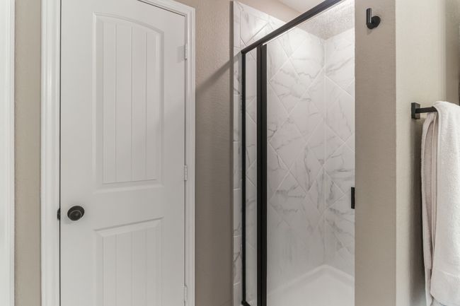 Full bath with a marble finish shower and a textured wall | Image 22