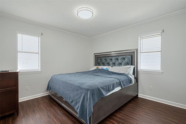 Primary bedroom with the neutral walls create a calming atmosphere, ideal for relaxation. | Image 16