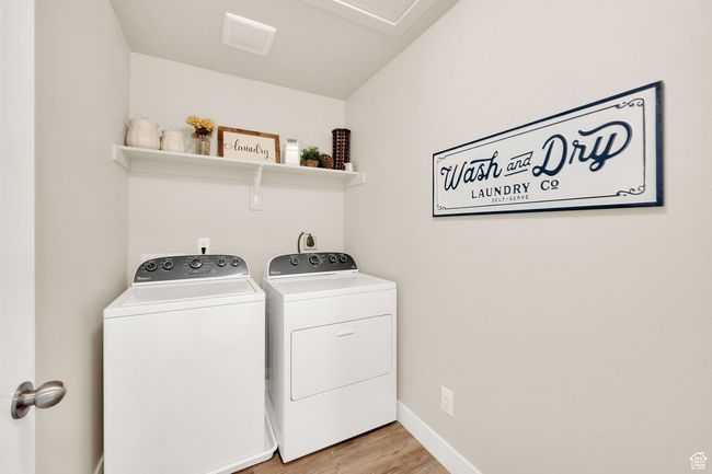 Laundry area featuring washer and dryer, light wood-style floors, and baseboards | Image 27