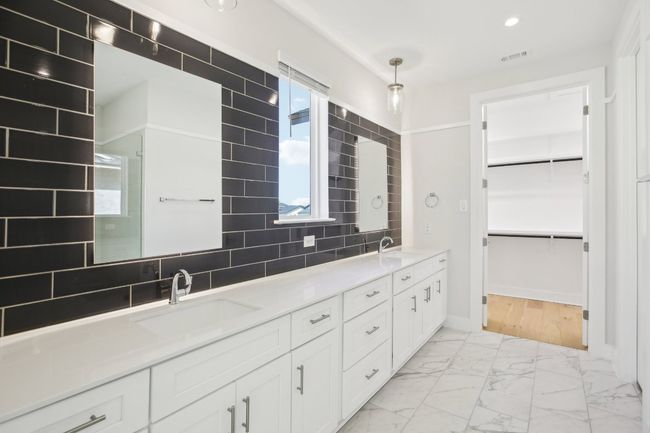 Full bath with a sink, a spacious closet, double vanity, and marble finish floor | Image 21