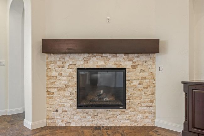 Enjoy a gas fireplace with the flip of a switch, enhanced with a beautiful wood mantel | Image 23