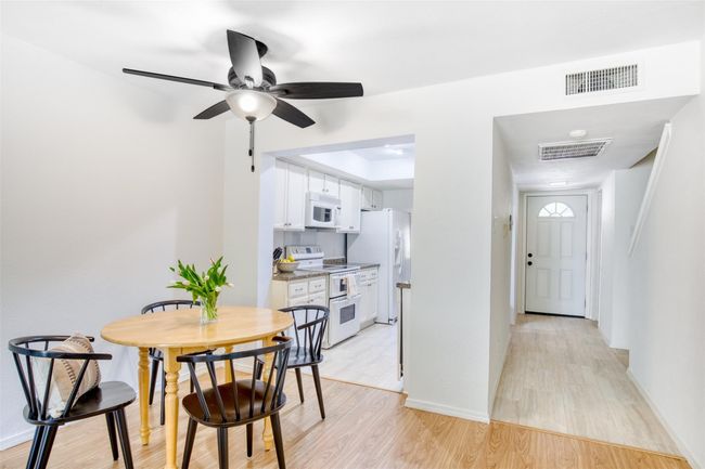 Dining room with light wood-type flooring and a ceiling fan | Image 12