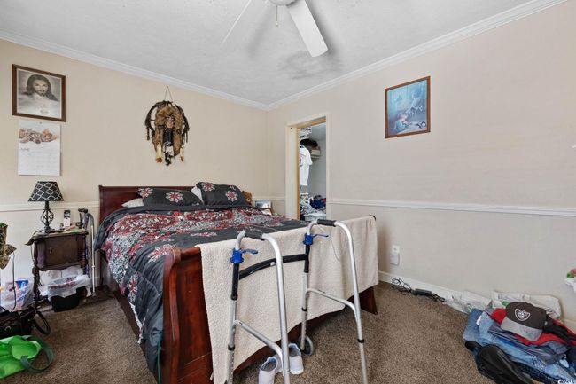 Bedroom featuring carpet flooring, ornamental molding, and a ceiling fan | Image 10