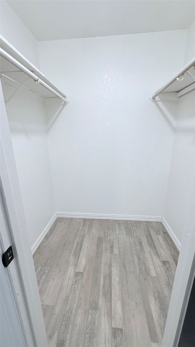 Walk in closet featuring wood finished floors | Image 12