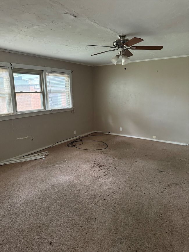 Carpeted spare room with a ceiling fan and ornamental molding | Image 6