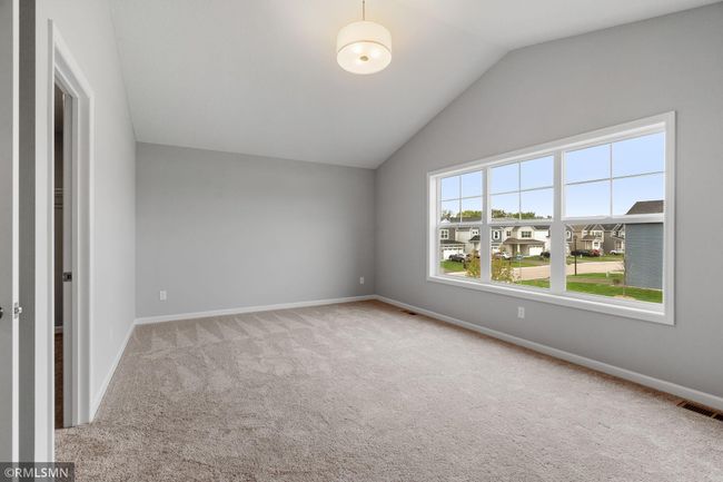 (Photo of previously finished home) Vaulted ceilings in the owner's suite enhance the flow of natural light. | Image 11