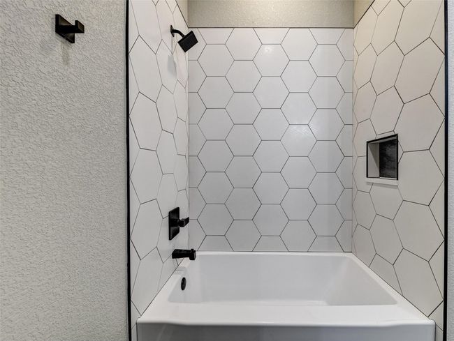 Bathroom featuring shower / washtub combination | Image 25