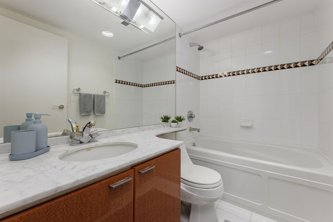 Full bath featuring vanity, toilet, and shower combination | Image 13