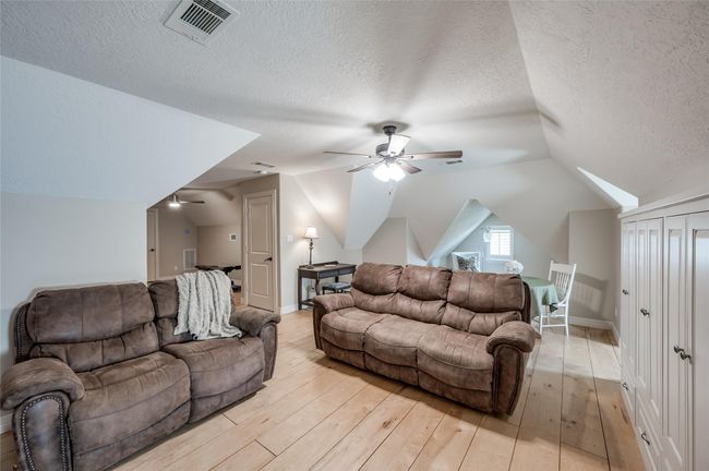 Beyond the living area, enjoy a cozy window nook with multiple seating options. | Image 28