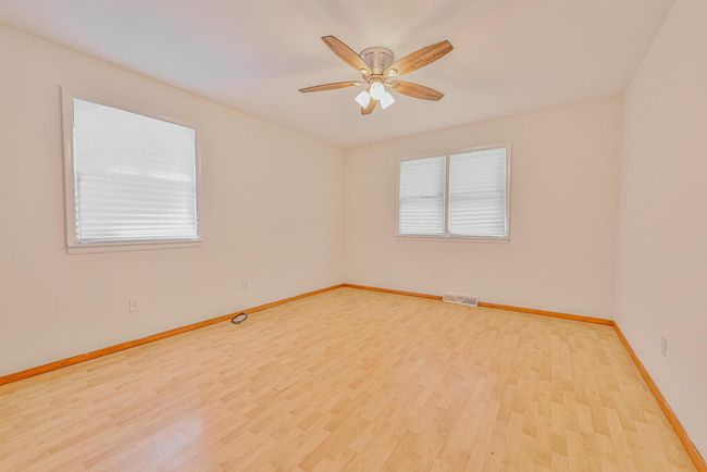 Spare room with wood finished floors and ceiling fan | Image 11