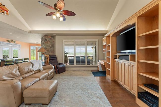 Living area featuring recessed lighting, ceiling fan with notable chandelier, vaulted ceiling, and dark wood finished floors | Image 11