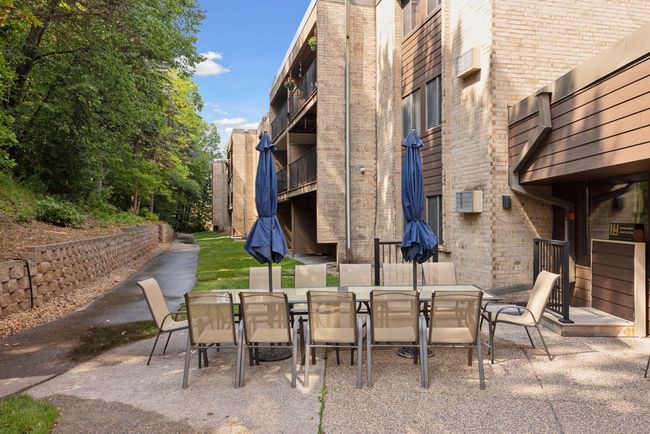 Generous community outdoor dining area surrounded by trees, perfect for alfresco meals and gatherings | Image 15