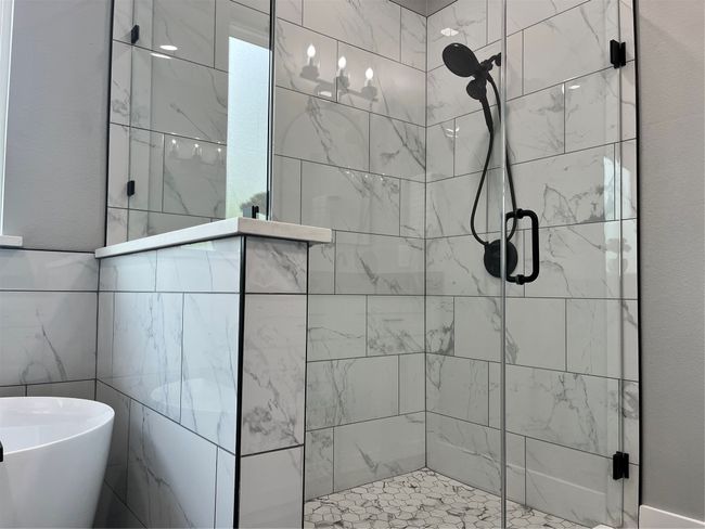Bathroom featuring a shower stall and a freestanding tub | Image 27