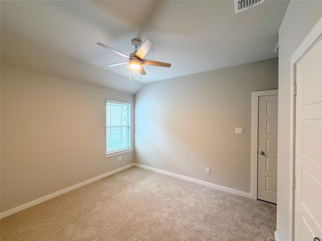 Spare room with a ceiling fan, baseboards, light carpet, and vaulted ceiling | Image 22