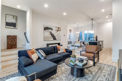 Living room featuring a notable chandelier and light hardwood / wood-style flooring | Image 2