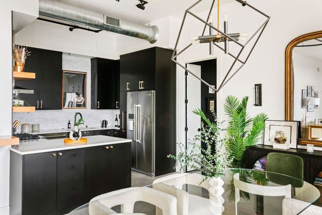 Kitchen featuring dark cabinets, backsplash, high end refrigerator, a peninsula, and open shelves | Image 13
