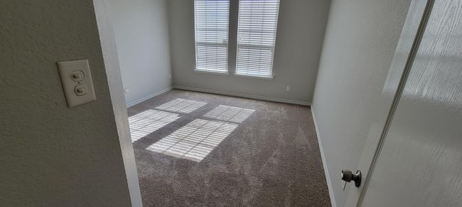 Unfurnished room with a textured wall and carpet floors | Image 12