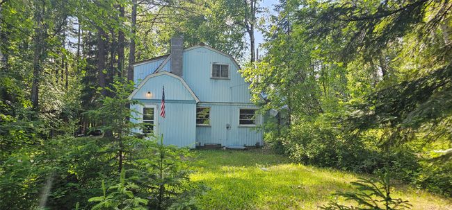 Back of property with a chimney and a gambrel roof | Image 12