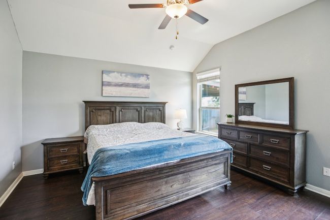 Bedroom featuring ceiling fan, vaulted ceiling, dark wood-type flooring, and baseboards | Image 15