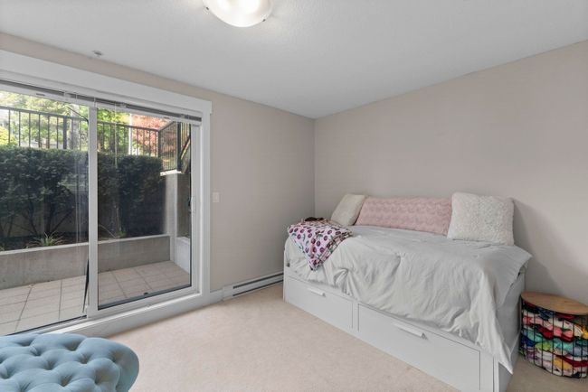 Carpeted bedroom featuring a baseboard radiator and access to exterior | Image 16