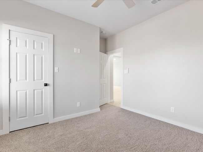 Unfurnished bedroom with visible vents, a ceiling fan, baseboards, and carpet floors | Image 16