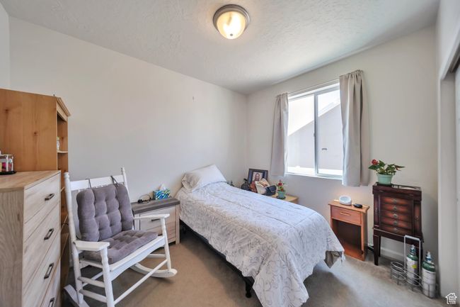 Bedroom with a textured ceiling | Image 17