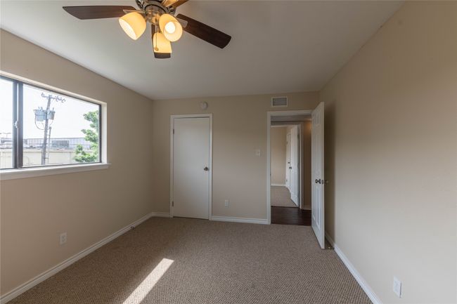 Unfurnished bedroom featuring carpet floors, baseboards, and a ceiling fan | Image 29