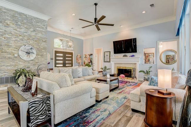 Spacious living room with gas fireplace and a stone veneer accent wall | Image 4