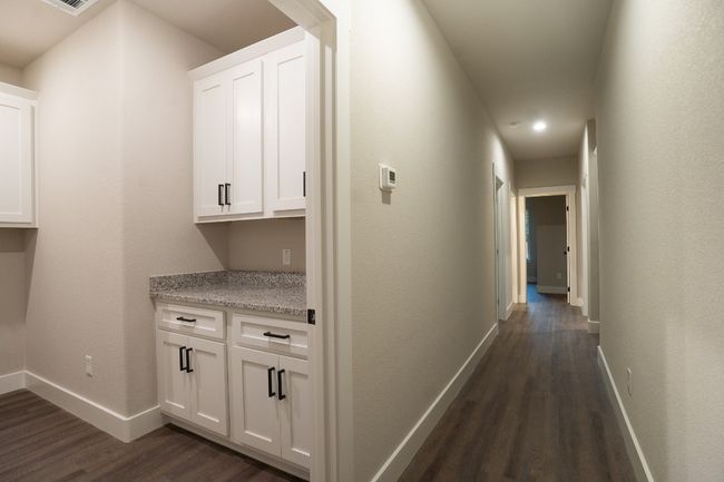 Hall with dark wood-style floors, baseboards, and recessed lighting | Image 21