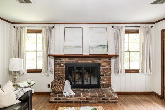 This room also has windows overlooking the back yard and mature trees. | Image 37