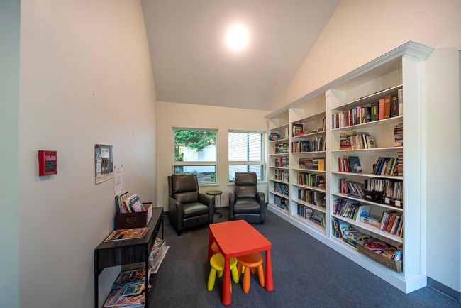 Sitting room with carpet floors and high vaulted ceiling | Image 4
