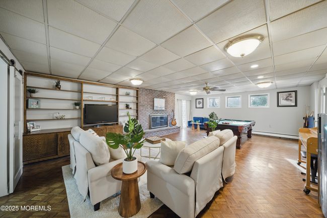 1st floor spacious living room with hw floors, fireplace, kitchenette nearby with sliders to level yard | Image 32
