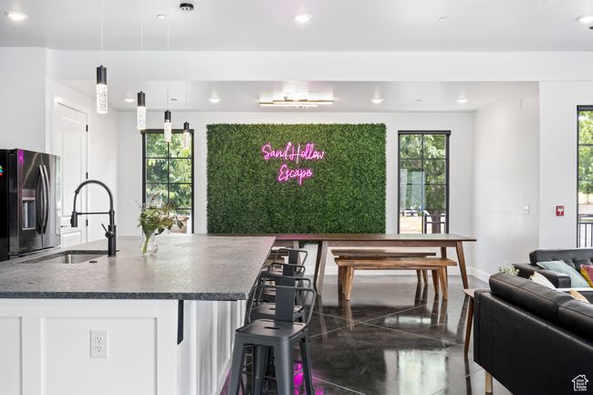 Kitchen with black fridge, plenty of natural light, sink, and pendant lighting | Image 9