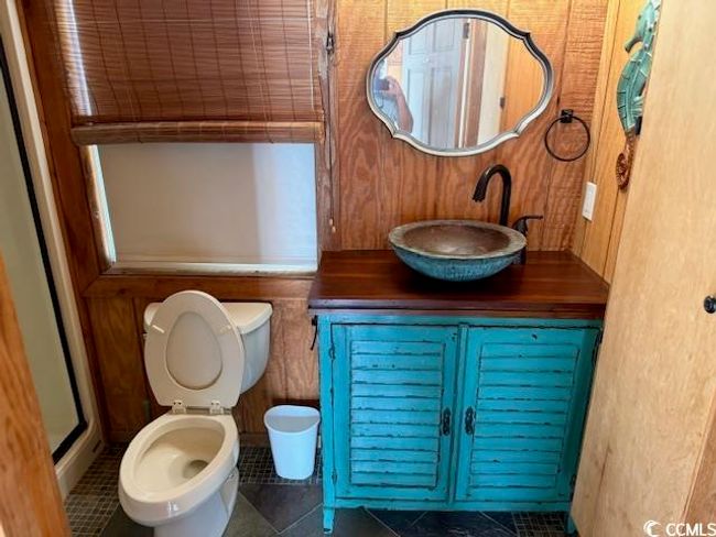 Bathroom with tile patterned floors, vanity, and a shower with door | Image 14