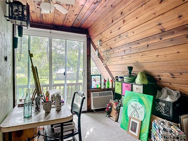 sliders in the loft lead to the French balcony, which overlooks the backyard and back patio area | Image 33