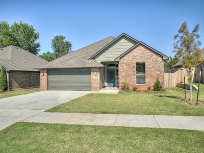 View of front of home featuring a front lawn and a garage | Image 1